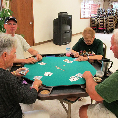 Card table with people playing cards