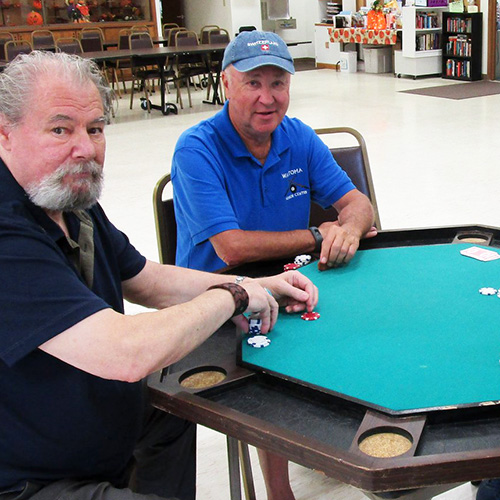 Two men playing cards & chips